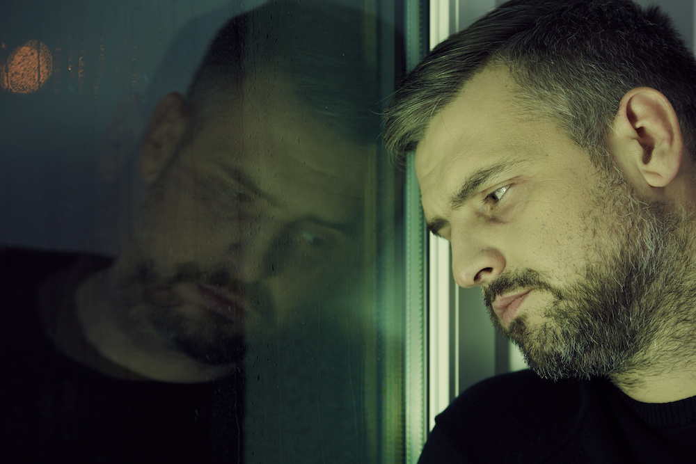 man thinking deeply after going to rehab