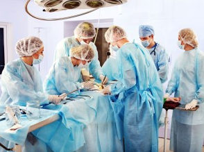 Surgeon and medical professionals in operating room